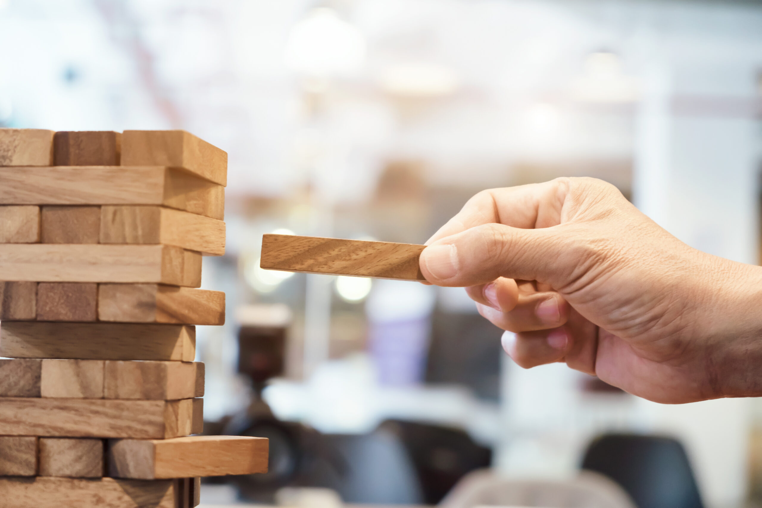 Planning, risk and strategy in business Planning, risk and strategy in business, businessman and engineer gambling placing wooden block on a tower